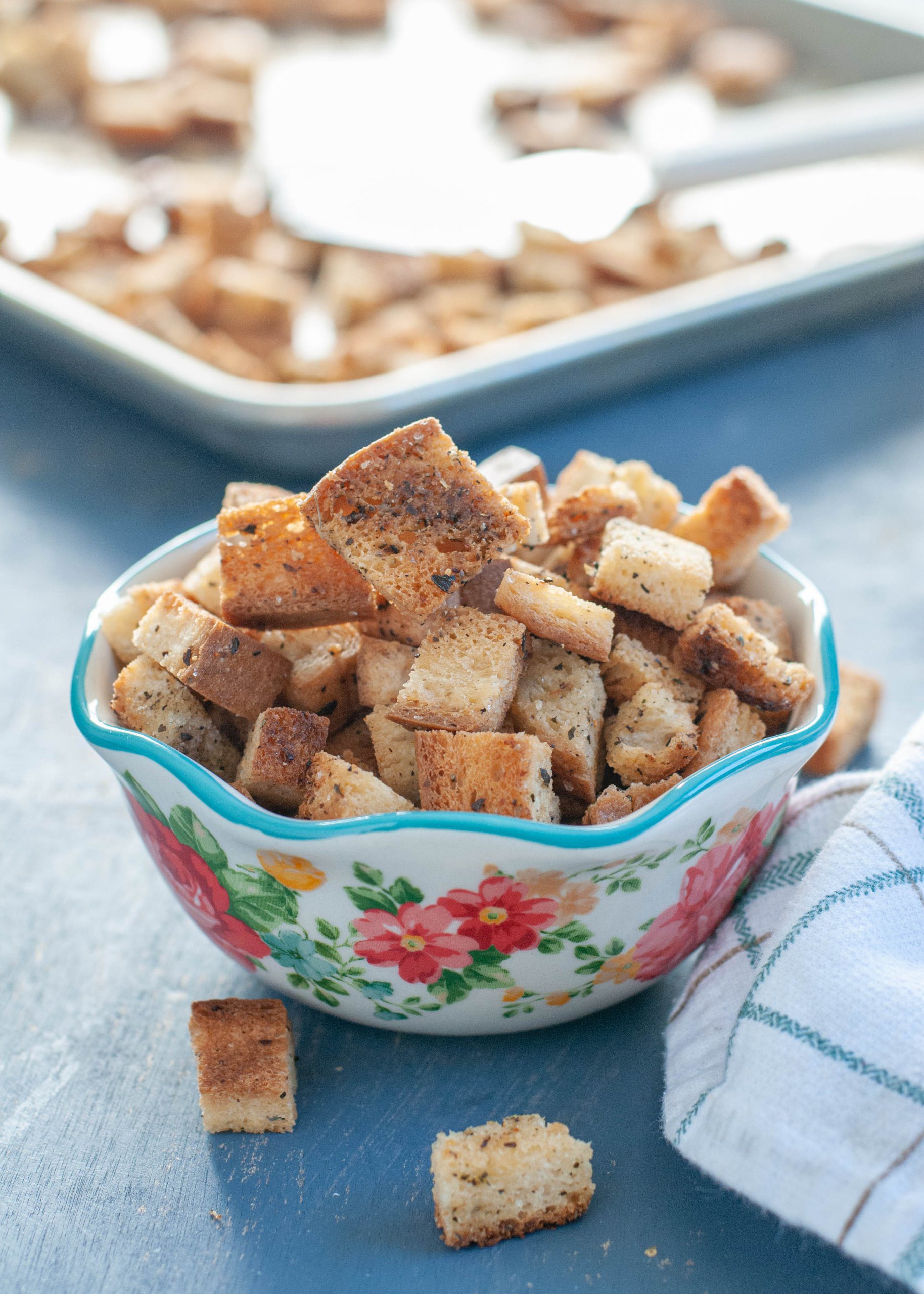 A close-up of a pan full of freshly baked gluten-free and vegan croutons, showcasing their golden color and crisp texture.
