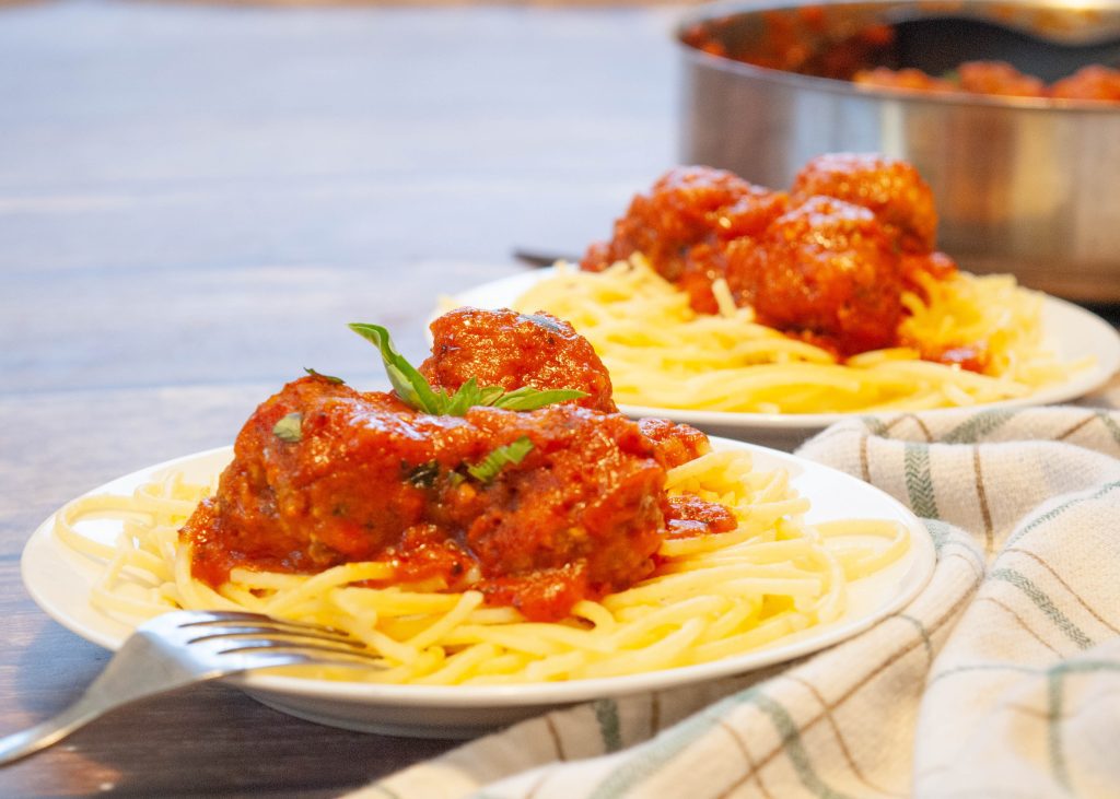 two-plates-of-gluten-free-spaghetti-with-meatballs-sitting-on-top
