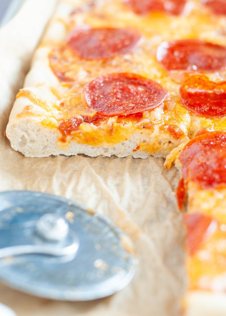 soft-gluten-free-pizza-crust-recipe-shown-with-slice-gone-from-an-angle