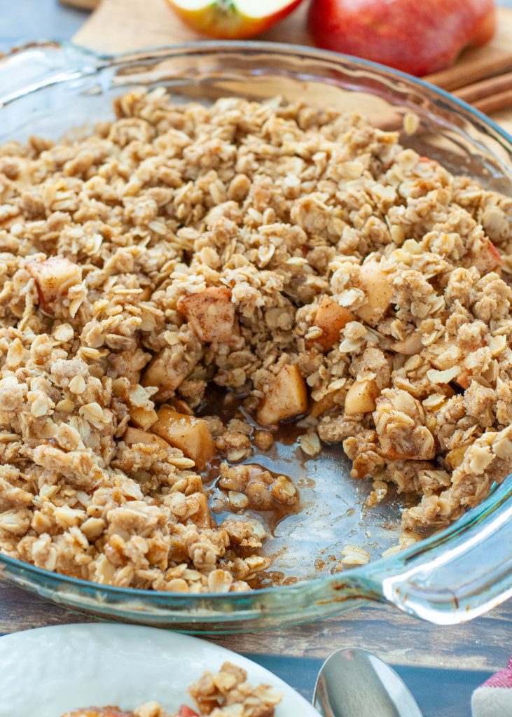 gluten-free-apple-crisp-in-a-glass-pie-plate-with-a-slice-taken-out