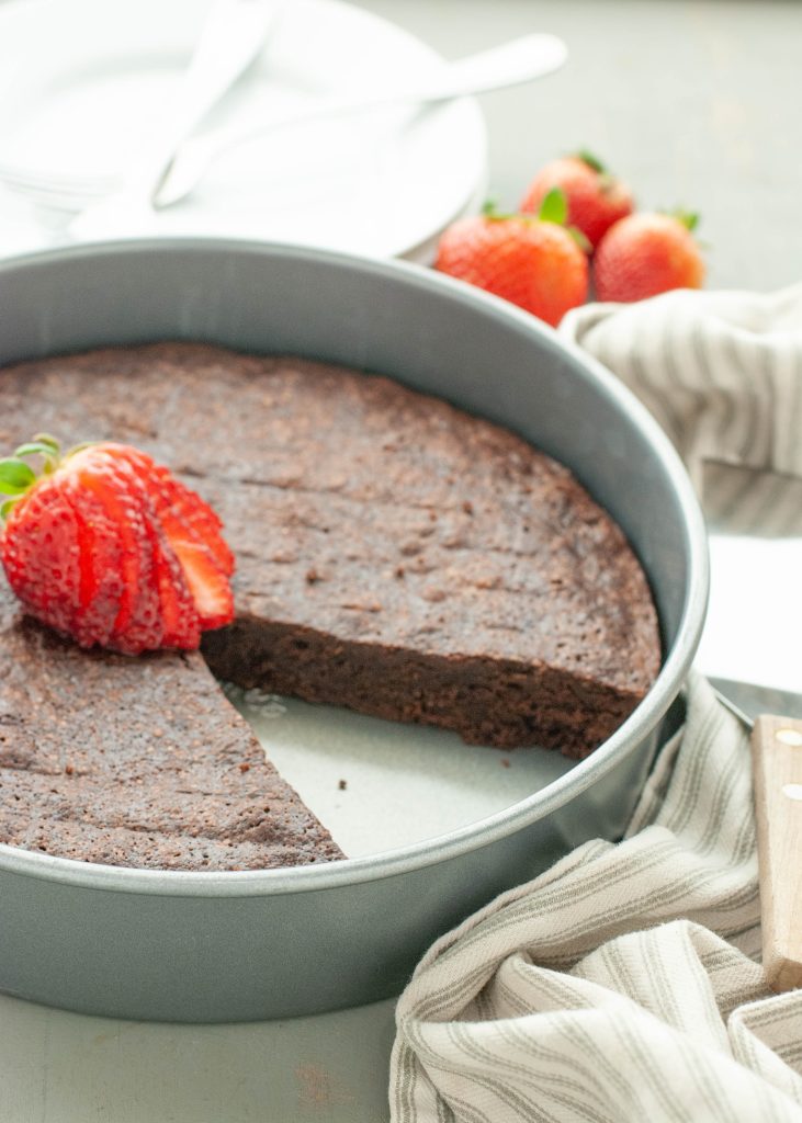 flourless-chocolate-torte-in-pan-with-slice-missing