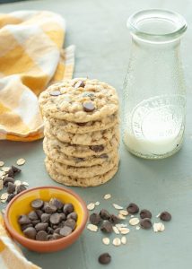 stacked-gluten-free-oatmeal-chocolate-chip-cookies-next-to-a-glass-of-milk