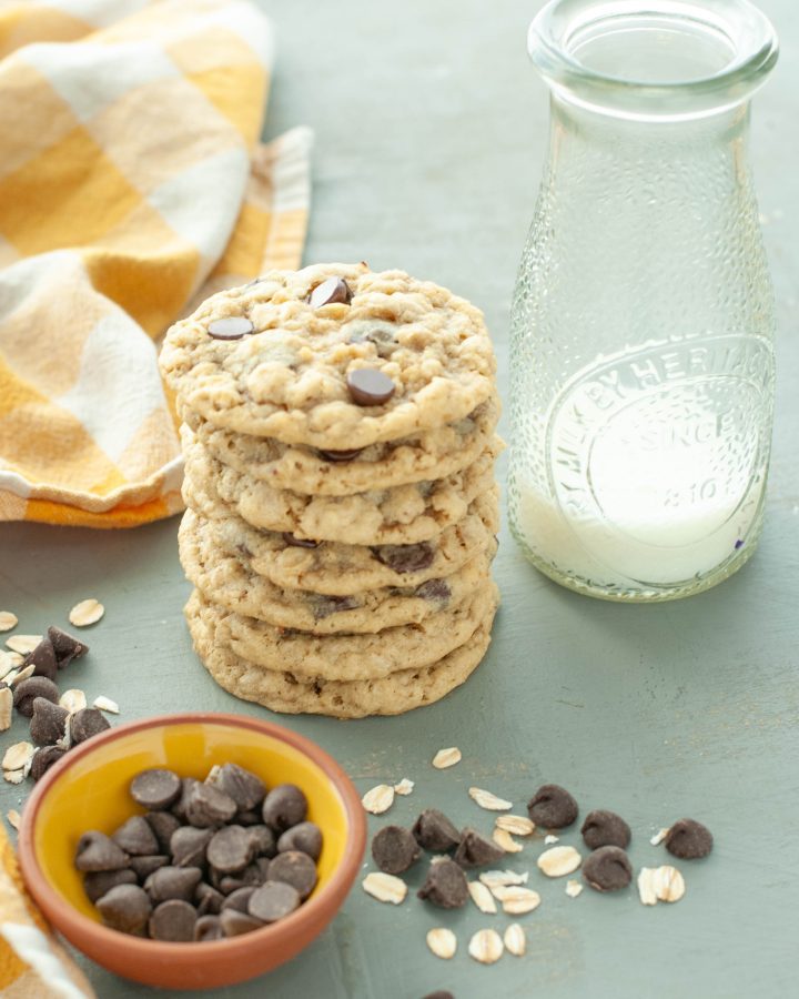 stacked-gluten-free-oatmeal-chocolate-chip-cookies-next-to-a-glass-of-milk