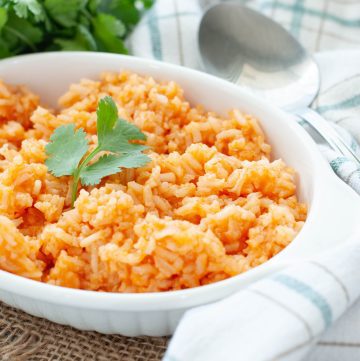 gluten-free-mexican-rice-in-a-white-dish-with-a-cilantro-garnish