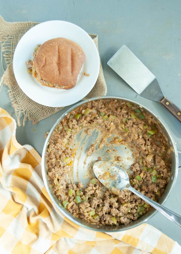 gluten-free-dairy-free-philly-cheesesteak-mixture-in-a-skillet-with-a-bun-on-a-plate